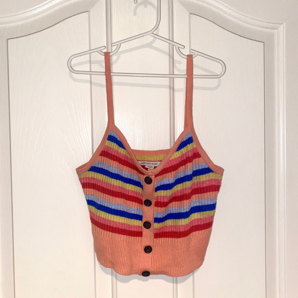 Peach color tank top with rainbow stripes and buttons down the middle